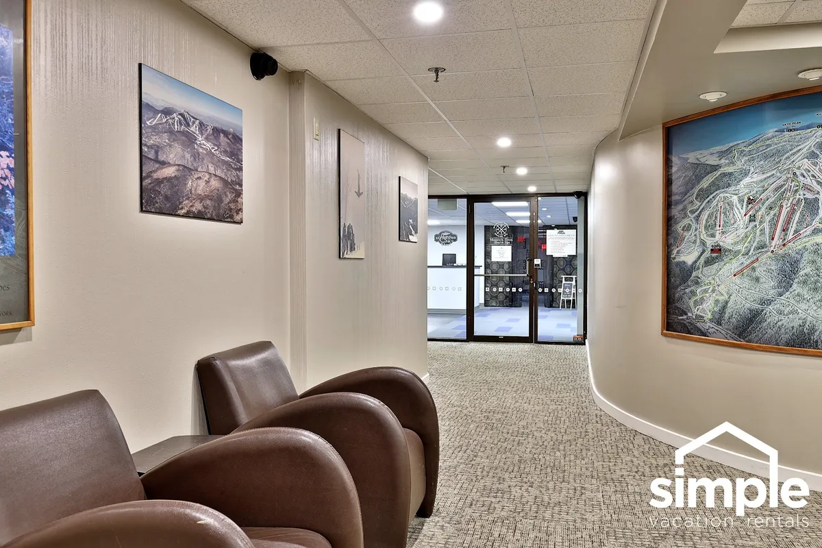 This image shows a pair of inviting armchairs set by a glass door, with wall art adding local flair. The glass door hints at easy access to the outdoors, creating a visual link to Vermont’s scenic experiences and outdoor adventures. The comfortable seating suggests a relaxing pause after a day of exploring.
